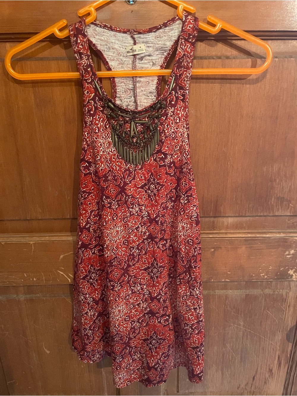 Fun tank top with metal décolletage embellished details on front
